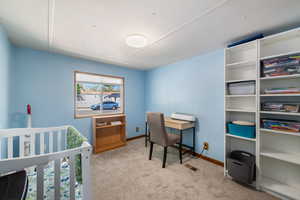 Bedroom with light carpet and baseboards