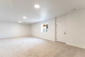 Unfurnished room featuring light carpet and recessed lighting