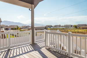Wooden deck featuring a residential view and a mountain view