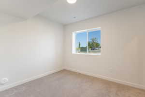 Spare room with carpet floors and baseboards