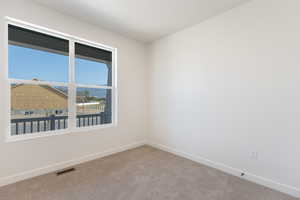 Spare room with baseboards and carpet flooring