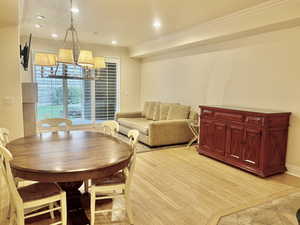 Dining area featuring recessed lighting, light wood-type flooring, and crown molding