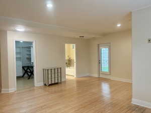 Empty room featuring light wood-style floors and recessed lighting