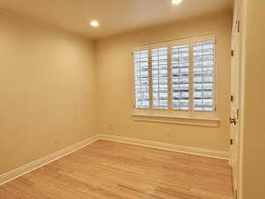 Empty room featuring wood finished floors, recessed lighting, and plenty of natural light