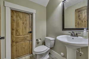 Bathroom with wood finished floors and toilet