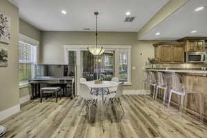 Dining space featuring recessed lighting and light wood-style floors