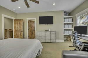 Bedroom with carpet floors, ceiling fan, recessed lighting, and an office area