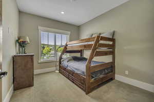 Bedroom with light carpet and recessed lighting
