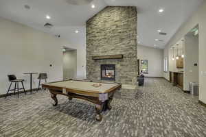 Recreation room featuring pool table, carpet, high vaulted ceiling, a fireplace, and recessed lighting