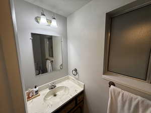 Bathroom with vanity and a textured ceiling