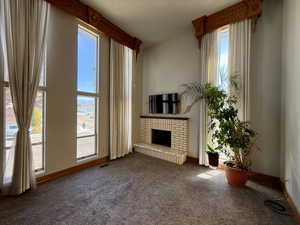Unfurnished living room with carpet floors and a fireplace