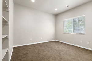 Carpeted empty room with recessed lighting and baseboards
