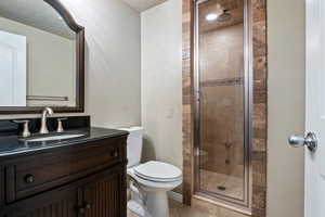 Bathroom with a shower stall, vanity, and light tile patterned floors