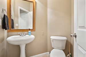 Bathroom with toilet and baseboards