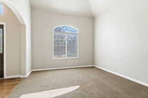 Formal Living Room with arched walkways and carpet floors