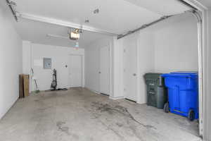 Garage featuring electric panel and a garage door opener