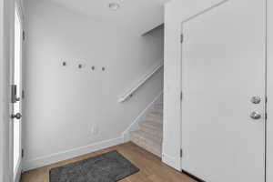 Entryway with light wood-style floors and stairway