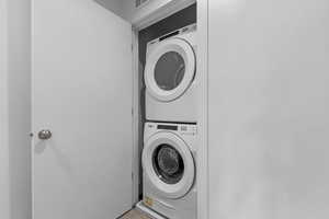 Laundry room featuring estacked washer and dryer