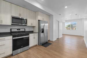 Kitchen featuring stainless steel appliances, light wood-style floors, modern cabinets, recessed lighting, and light brown cabinetry