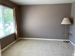 Carpeted empty room with baseboards