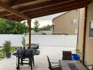 Fenced backyard featuring outdoor dining space and a patio area