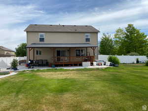 Rear view of property featuring a patio area, stucco siding, a fenced backyard, and a deck