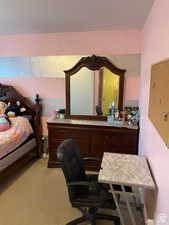 Bedroom featuring light carpet