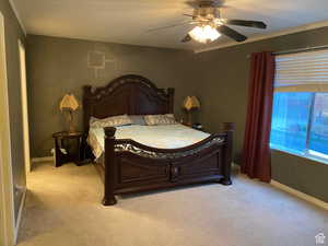 Bedroom with light carpet and a ceiling fan