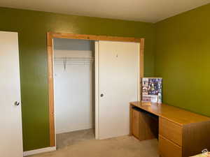 Unfurnished office with light carpet and baseboards