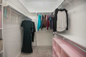 Walk in closet featuring light carpet