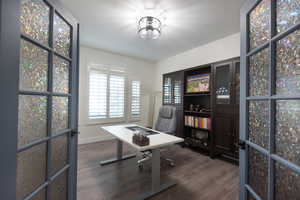 Office space featuring dark wood finished floors and baseboards