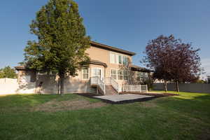 Rear view of house featuring a patio and stucco siding