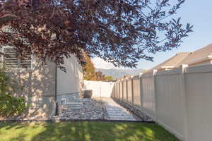 Fenced backyard featuring a mountain view and a gate