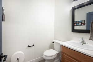 Half bath featuring vanity and toilet