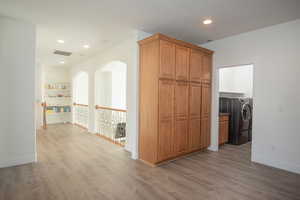 Kitchen with brown cabinetry, dark wood-style floors, and recessed lighting