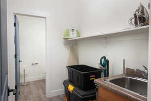 Washroom featuring a sink and light wood-style flooring