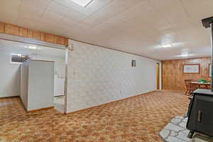 Finished below grade area featuring light colored carpet and washer / clothes dryer