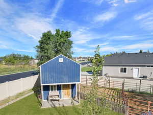 View of outbuilding with a fenced backyard