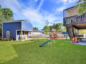 View of playground with a patio, stairs, and a deck