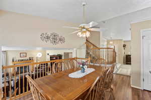 Dining space featuring vaulted ceiling and French doors leading to a large deck