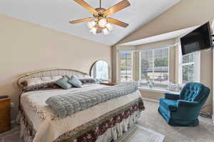 Master bedroom includes French doors, bay window with window seat, and vaulted ceiling