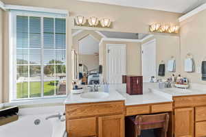 Ensuite bathroom with double vanity, a garden tub, and separate shower stall