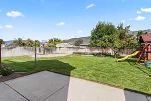 Large, fenced backyard with mountain views and patio