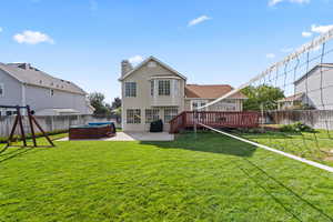 Back of house with patio area and large deck