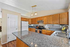 Kitchen with stainless steel appliances, pantry, and granite countertops