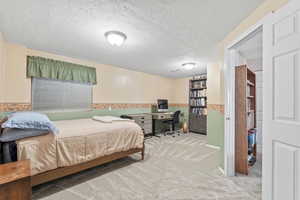 Oversized bedroom with clothes closet and a second closet with shelves