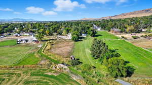 Aerial view of property and surrounding area with rural landscape and mountains