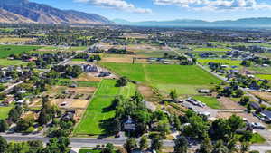 Aerial overview of property's location featuring a mountain backdrop and rural landscape