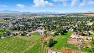Aerial view of property and surrounding area with mountains and rural landscape