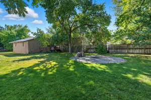 View of yard featuring an outbuilding and a patio area